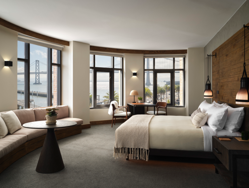 1 Hotel San Francisco waterfront suite with bay-view windows and natural wood design.