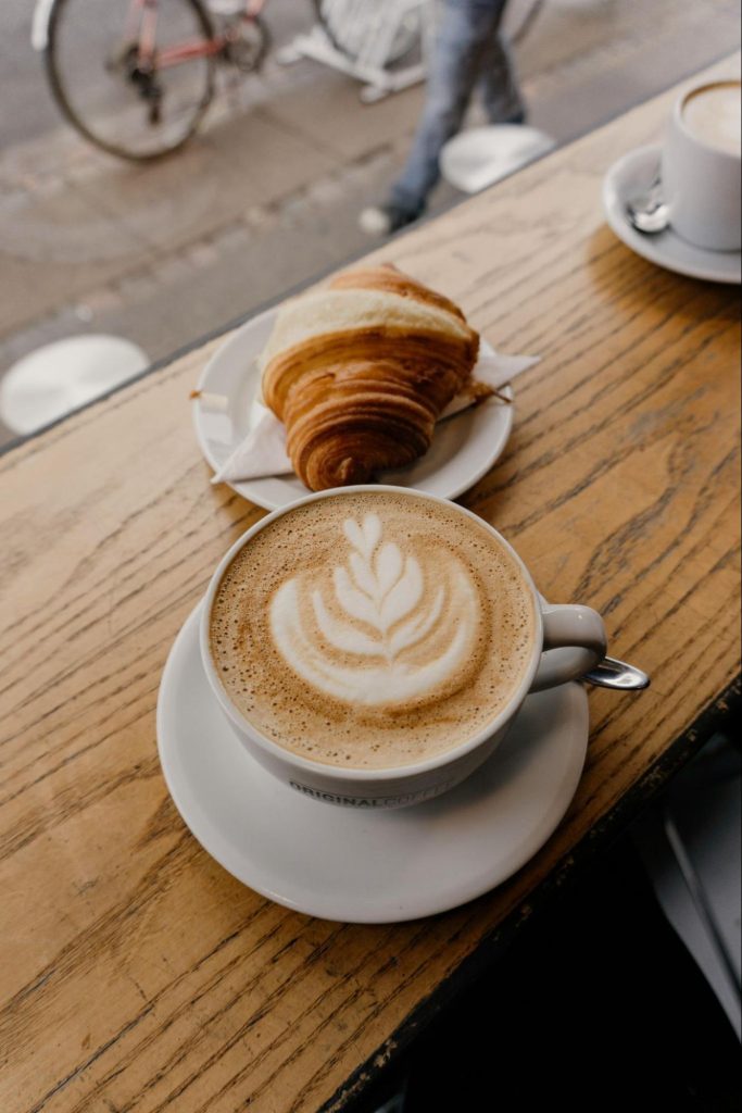 Coffee and croissant on café table in Copenhagen