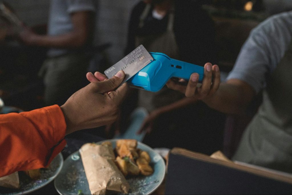 Customer paying by card at restaurant terminal