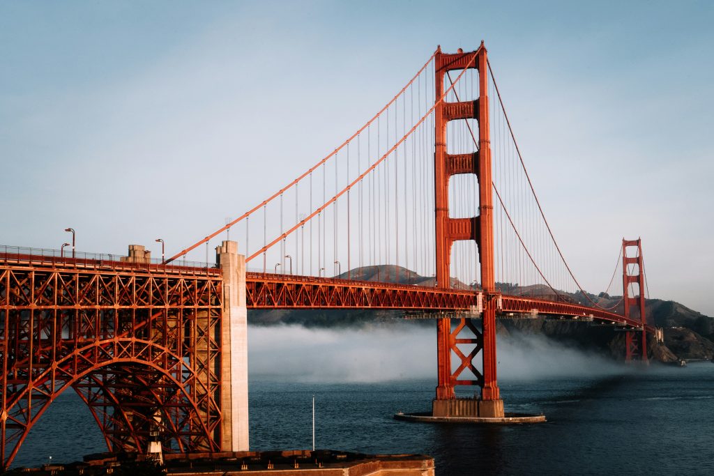 Golden Gate Bridge in San Francisco above the bay with low fog