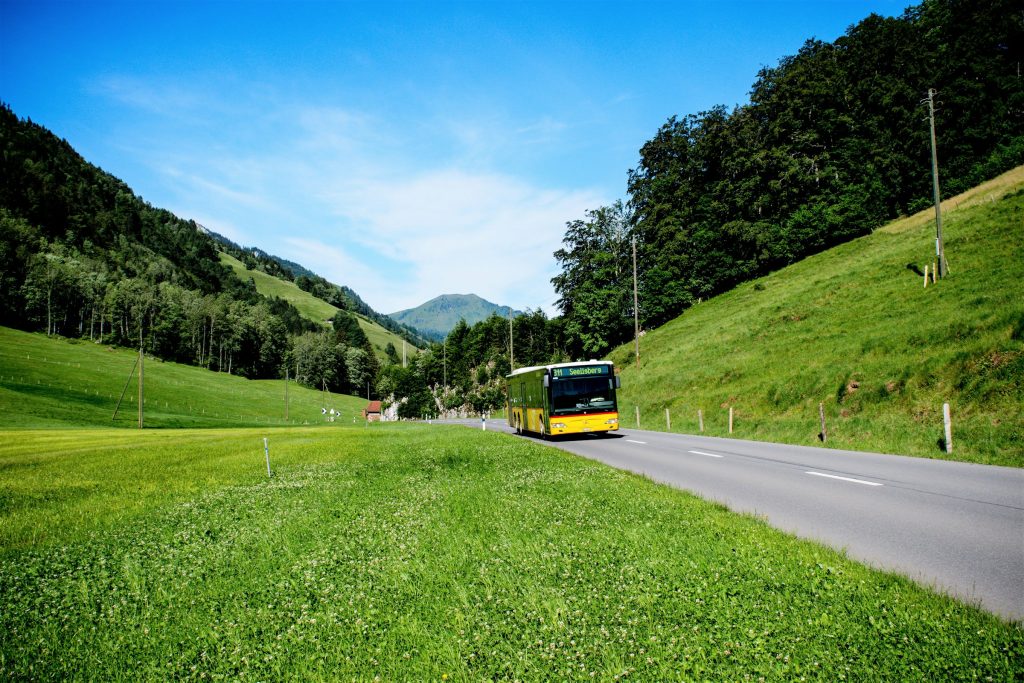 Swiss regional bus driving through countryside