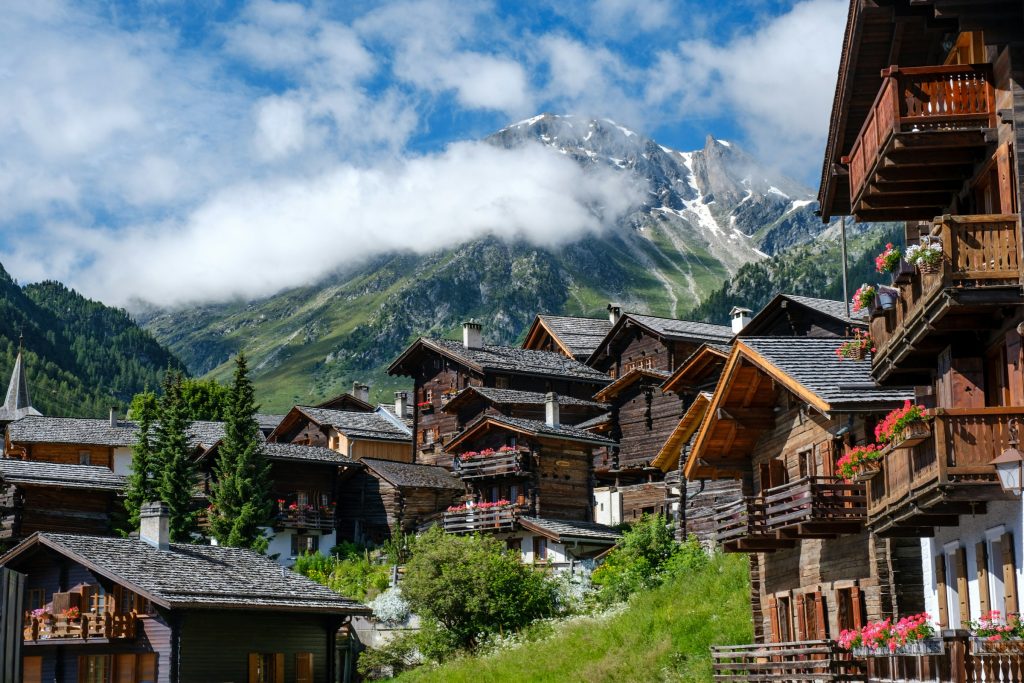 Traditional Swiss alpine village with mountains