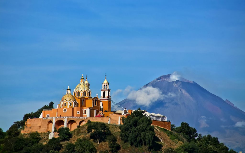 Santuario de Nuestra Señora de los Remedios church in Cholula with Popocatépetl volcano in the background, Mexico.